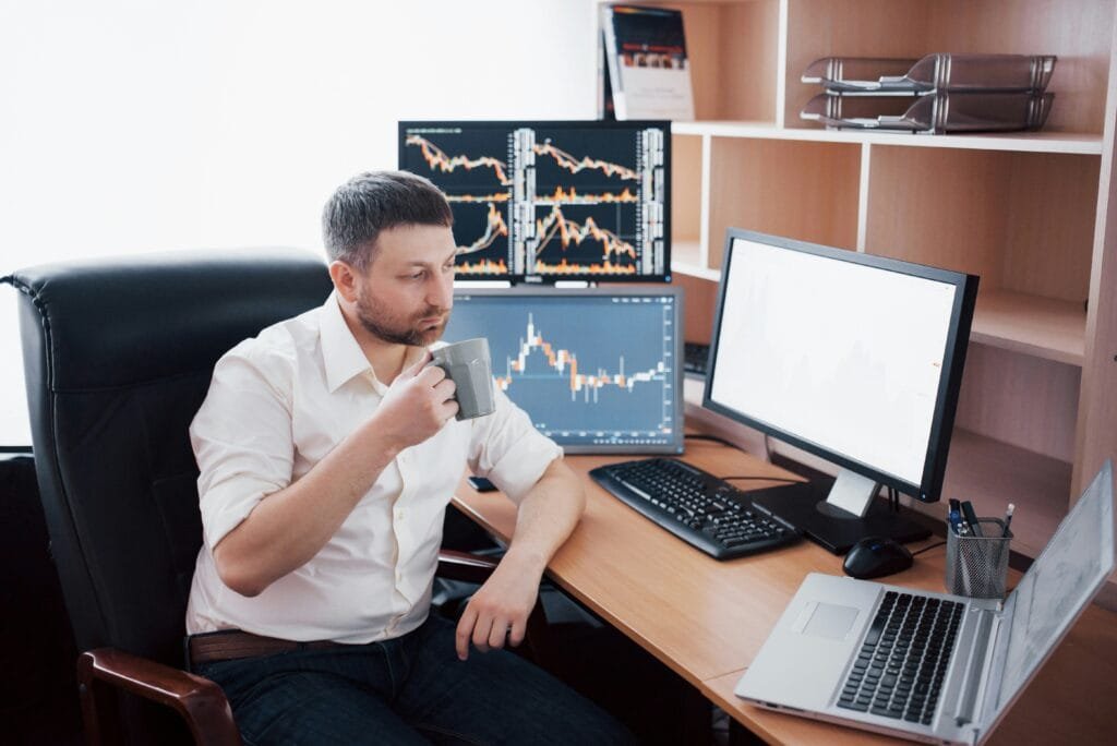 Man looking at trading screens