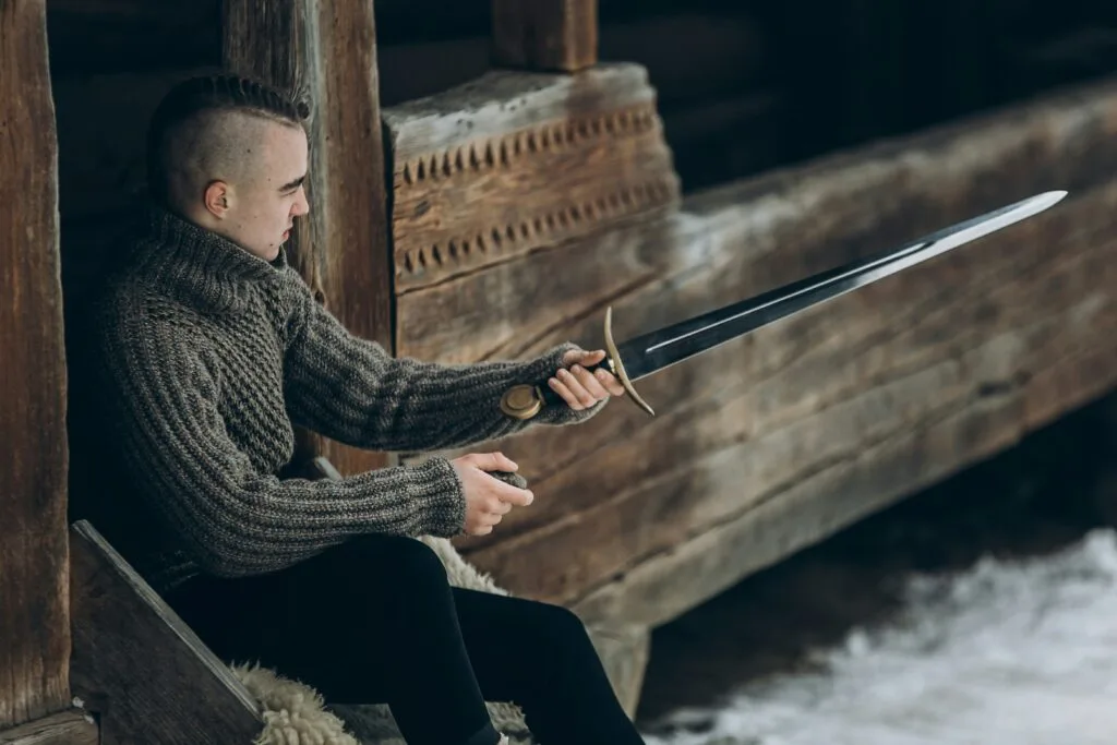 Man holding a sword showing how leverage is a double-edged sword