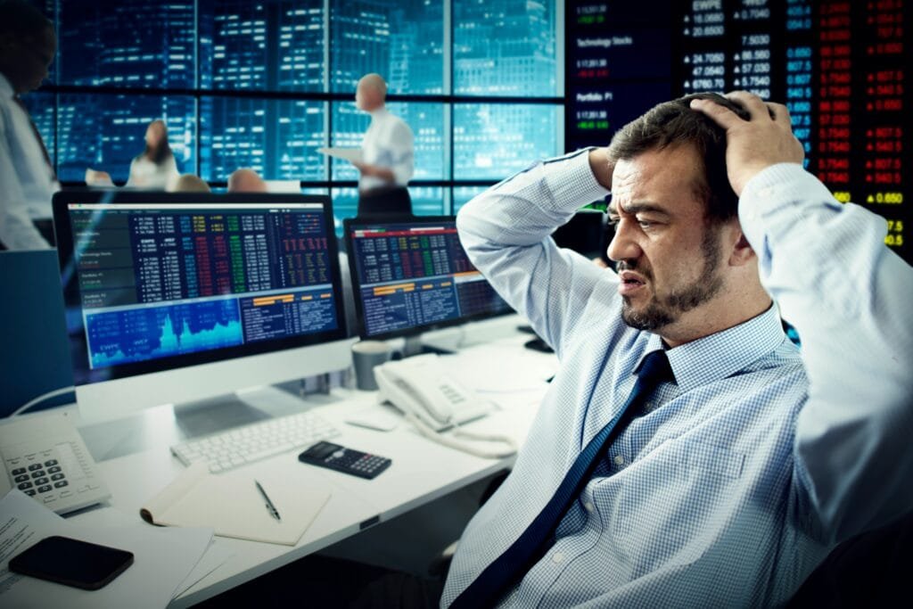 Man panicking looking at trading screen