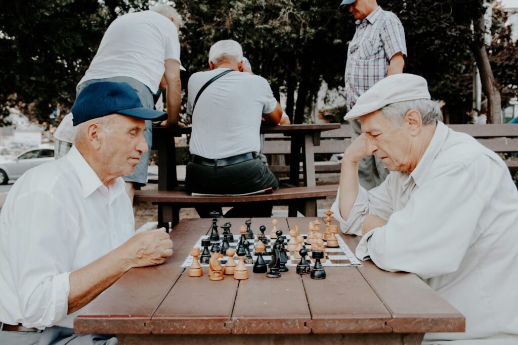 Two old men playing chess indicating seasoned strategic traders